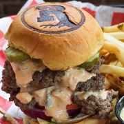 This is the restaurant logo for Roots Burger Bar - Carmel